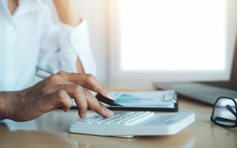 finances-saveing-economy-concept-female-accountant-banker-use-calculator-min